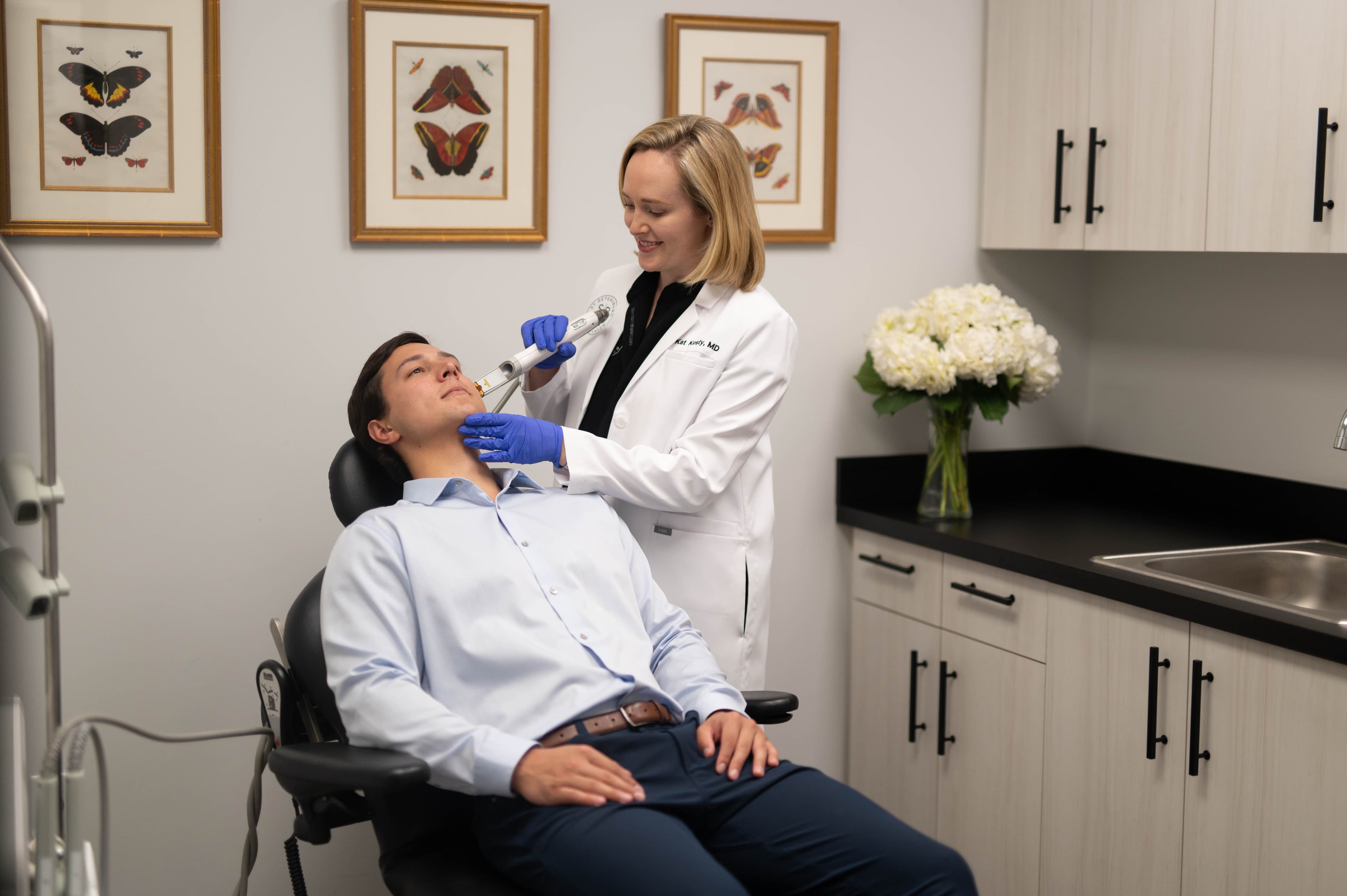 Dr. Kat Kesty performing advanced laser eye treatment on male patient